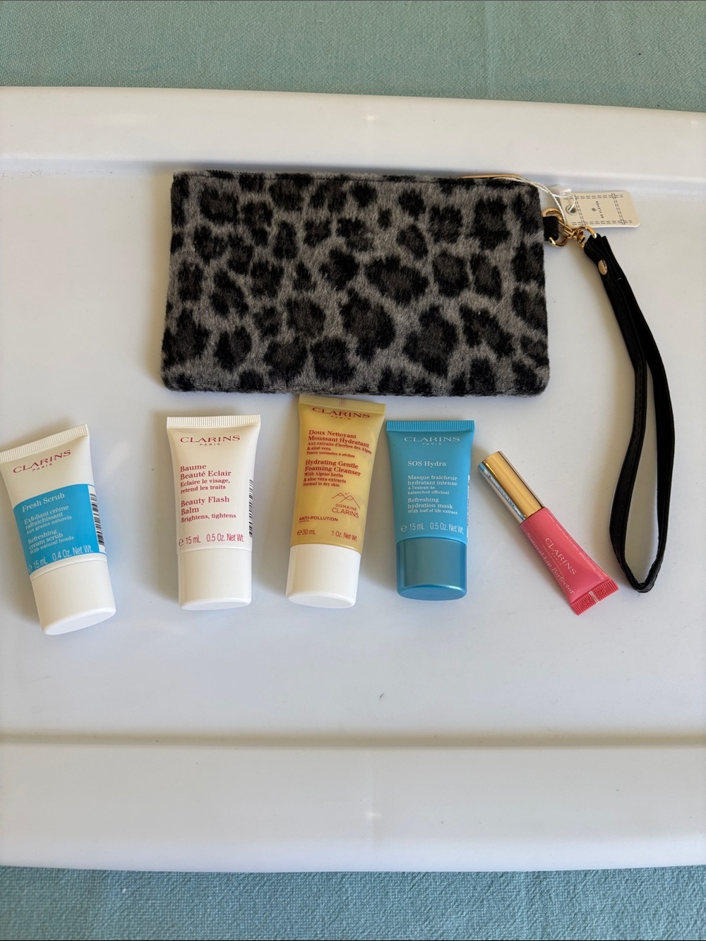 Clarins cream tubes with aqua and coral labels